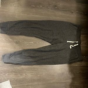 Dark grey joggers. Ankles are cuffed